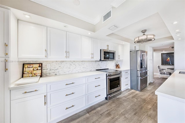 4000 Towerside Ter Unit 1507, Miami, FL 33138 - kitchen with appliances with stainless steel finishes, white cabinetry, decorative backsplash, light countertops, and crown molding