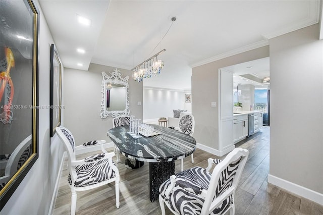 4000 Towerside Ter Unit 1507, Miami, FL 33138 - dining room featuring wood finished floors, crown molding, a chandelier, and recessed lighting