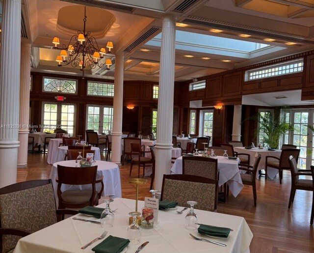 4000 Towerside Ter Unit 1507, Miami, FL 33138 - dining room featuring decorative columns, healthy amount of natural light, a chandelier, and a high ceiling