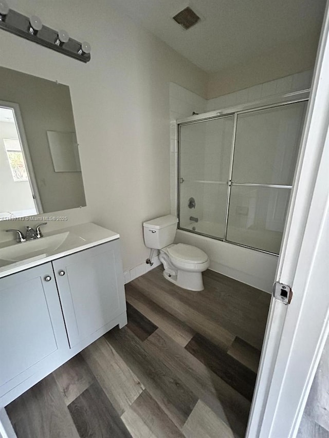 8297 SW 25th Ct Unit 101, Miramar, FL 33025 - bathroom featuring vanity, combined bath / shower with glass door, and wood finished floors
