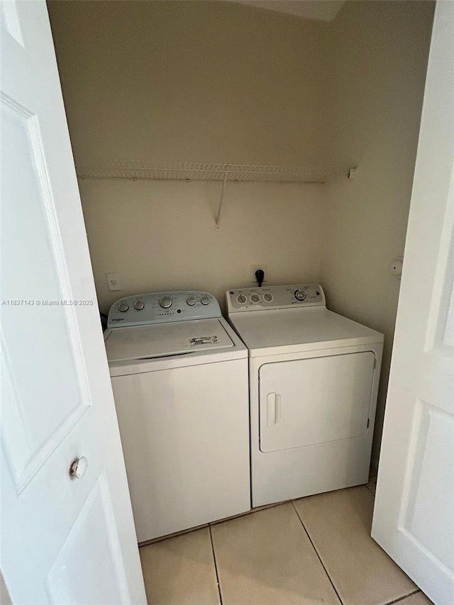 8297 SW 25th Ct Unit 101, Miramar, FL 33025 - laundry room with independent washer and dryer and light tile patterned floors