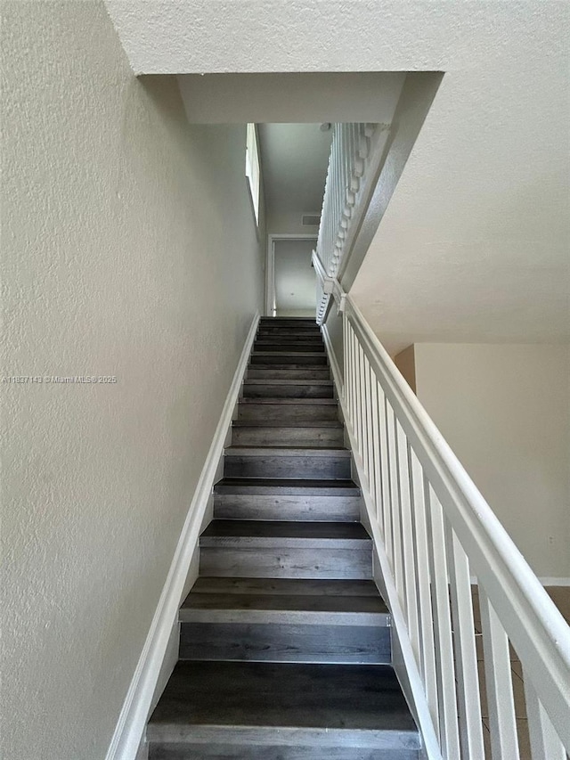 8297 SW 25th Ct Unit 101, Miramar, FL 33025 - stairway with a textured wall and wood finished floors