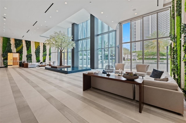 851 NE 1st Ave Unit 2809, Miami, FL 33132 - building lobby featuring a towering ceiling, expansive windows, and recessed lighting