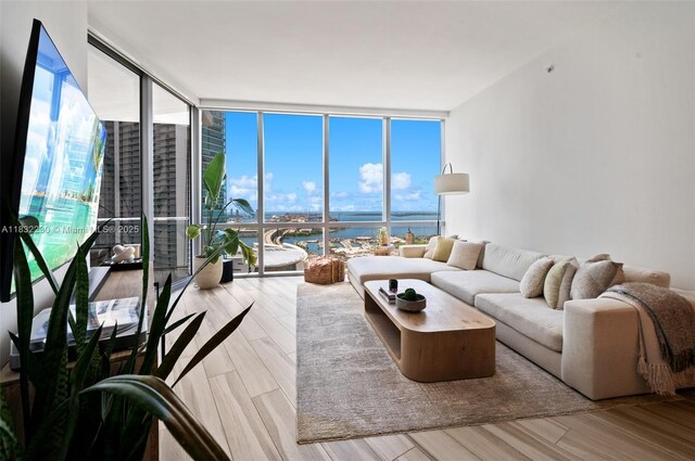 851 NE 1st Ave Unit 2809, Miami, FL 33132 - living area with expansive windows, wood finished floors, and a water view