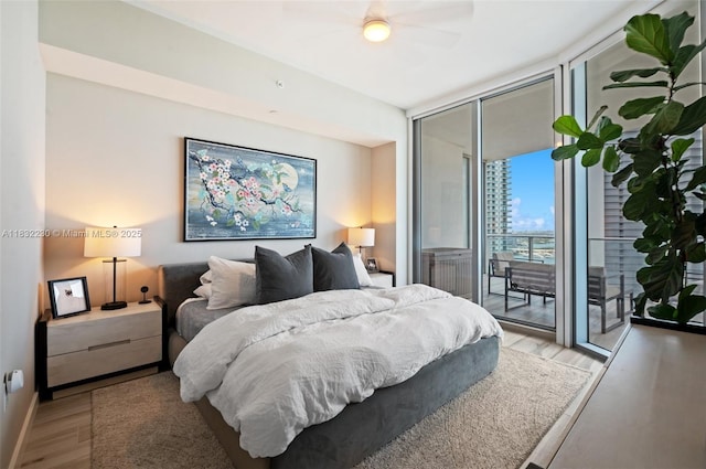 851 NE 1st Ave Unit 2809, Miami, FL 33132 - bedroom featuring wood finished floors, a wall of windows, access to outside, and a ceiling fan