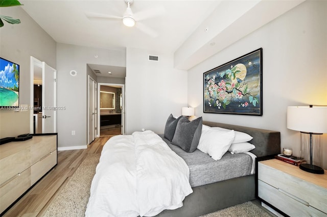 851 NE 1st Ave Unit 2809, Miami, FL 33132 - bedroom with wood finished floors, ensuite bath, and a ceiling fan
