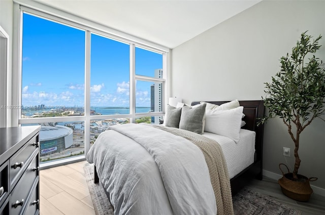 851 NE 1st Ave Unit 2809, Miami, FL 33132 - bedroom featuring expansive windows, a view of city, and a water view