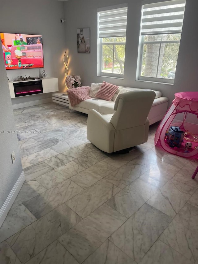 4301 SW 160th Ave Unit 215, Miramar, FL 33027 - living room with marble look tile flooring and a fireplace