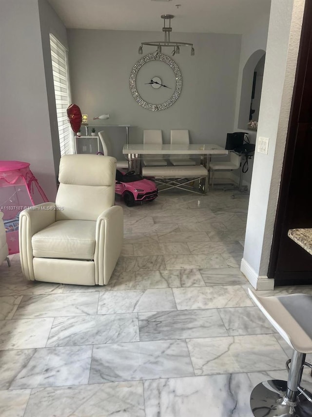 4301 SW 160th Ave Unit 215, Miramar, FL 33027 - living room with arched walkways and marble look tile flooring