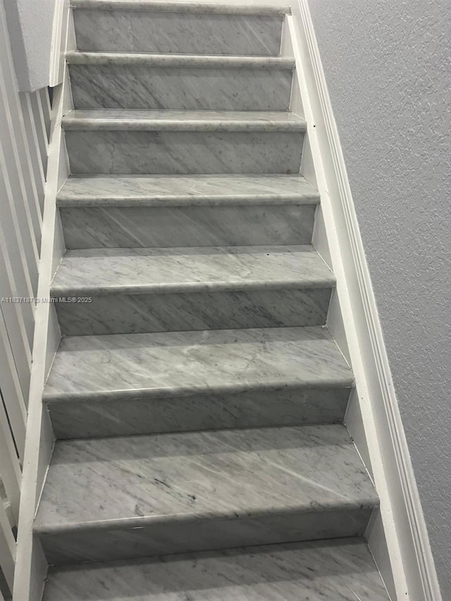 4301 SW 160th Ave Unit 215, Miramar, FL 33027 - stairway featuring a textured wall