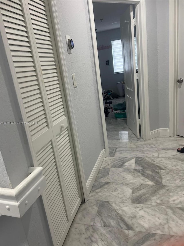 4301 SW 160th Ave Unit 215, Miramar, FL 33027 - hallway featuring light marble finish floors and a textured wall
