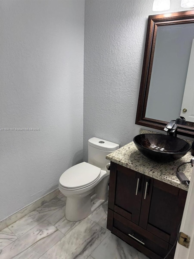 4301 SW 160th Ave Unit 215, Miramar, FL 33027 - bathroom with vanity, marble finish flooring, and a textured wall