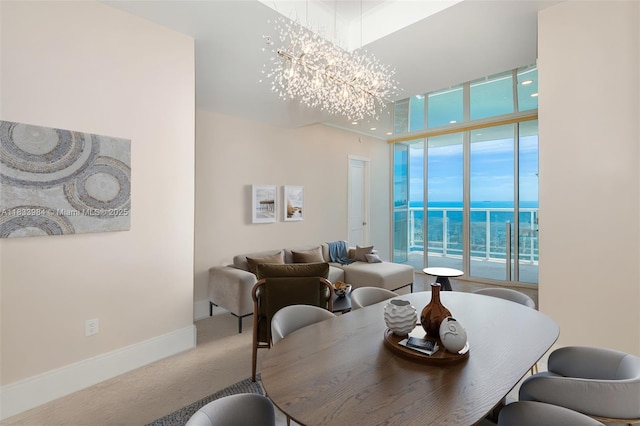 18101 Collins Ave Unit Ph5104, Sunny Isles Beach, FL 33160 - carpeted dining room with a chandelier, a wall of windows, a water view, and a towering ceiling