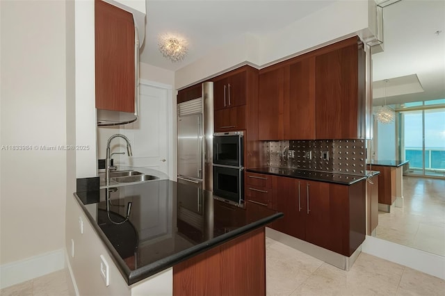 18101 Collins Ave Unit Ph5104, Sunny Isles Beach, FL 33160 - kitchen featuring dark countertops, stainless steel appliances, a peninsula, and modern cabinets