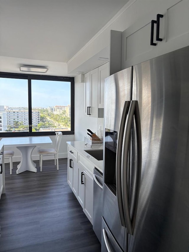 3589 S Ocean Blvd Unit 914, South Palm Beach, FL 33480 - kitchen with stainless steel appliances, a view of city, dark wood-style flooring, white cabinets, and light countertops
