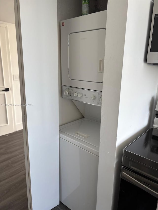 3589 S Ocean Blvd Unit 914, South Palm Beach, FL 33480 - washroom with estacked washer and dryer and dark wood-style floors
