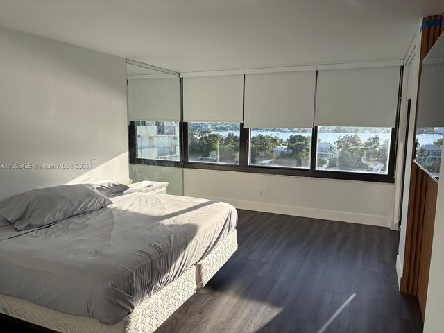 3589 S Ocean Blvd Unit 914, South Palm Beach, FL 33480 - bedroom featuring multiple windows and dark wood finished floors