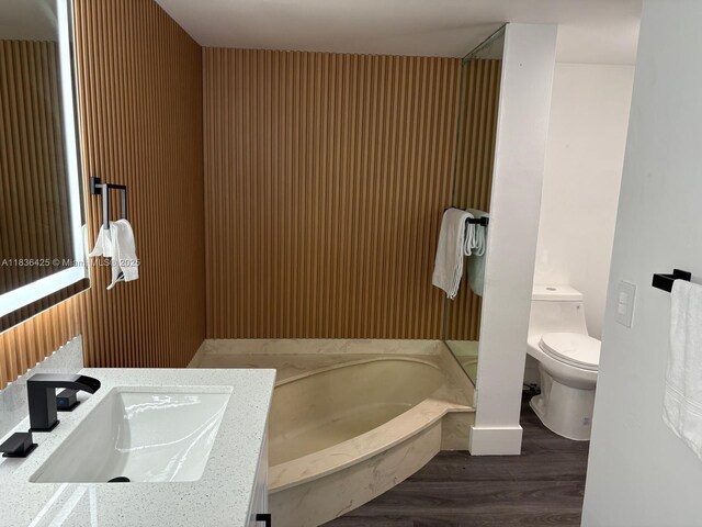 3589 S Ocean Blvd Unit 914, South Palm Beach, FL 33480 - bathroom featuring a garden tub, vanity, and wood finished floors
