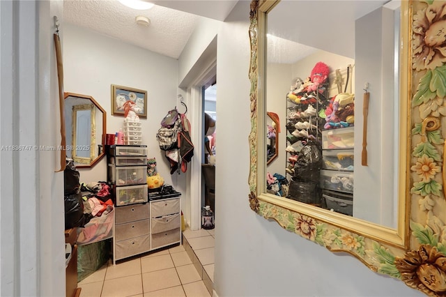 2220 SW 12th St, Miami, FL 33135 - hallway with light tile patterned floors and a textured ceiling