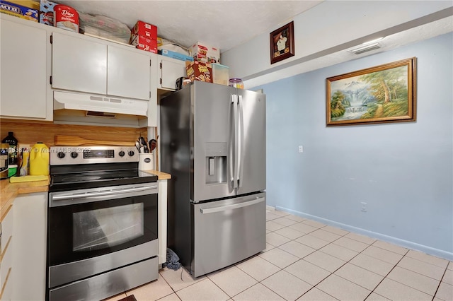 2220 SW 12th St, Miami, FL 33135 - kitchen with appliances with stainless steel finishes, under cabinet range hood, light countertops, light tile patterned floors, and white cabinets