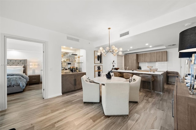 801 S Miami Ave Unit 1210, Miami, FL 33130 - dining area featuring a chandelier, light wood finished floors, and recessed lighting