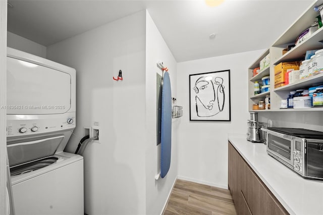 801 S Miami Ave Unit 1210, Miami, FL 33130 - laundry room featuring stacked washer / drying machine and light wood-type flooring