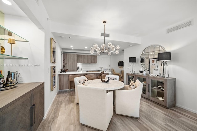 801 S Miami Ave Unit 1210, Miami, FL 33130 - dining space with light wood-type flooring, a chandelier, and recessed lighting