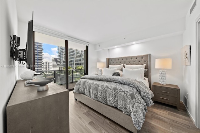 801 S Miami Ave Unit 1210, Miami, FL 33130 - bedroom featuring floor to ceiling windows, wood finished floors, and access to outside