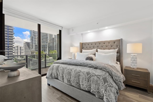 801 S Miami Ave Unit 1210, Miami, FL 33130 - bedroom featuring expansive windows, a city view, wood finished floors, and access to outside