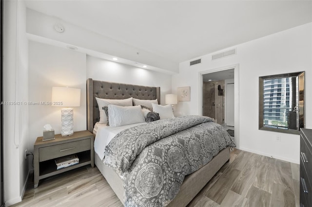 801 S Miami Ave Unit 1210, Miami, FL 33130 - bedroom with light wood-style floors and connected bathroom