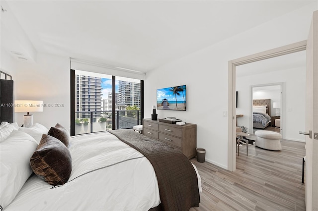 801 S Miami Ave Unit 1210, Miami, FL 33130 - bedroom with light wood-style flooring and expansive windows