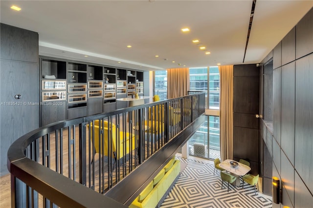 801 S Miami Ave Unit 1210, Miami, FL 33130 - hallway featuring a wall of windows, recessed lighting, and an upstairs landing