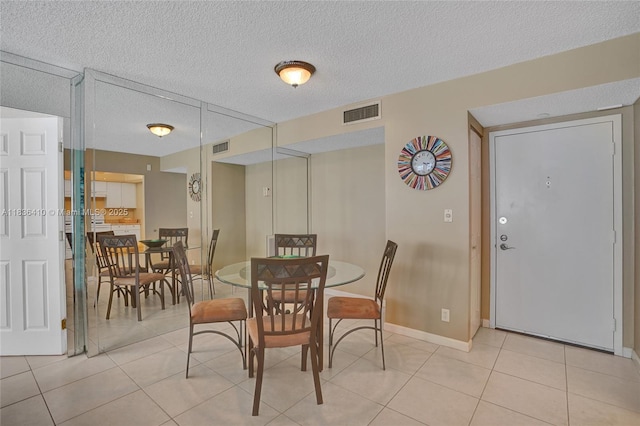 531 N Ocean Blvd Unit 1108, Pompano Beach, FL 33062 - dining area with light tile patterned floors and a textured ceiling