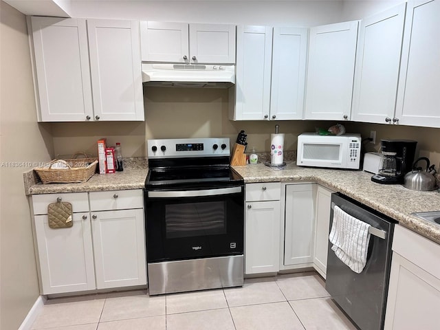 531 N Ocean Blvd Unit 1108, Pompano Beach, FL 33062 - kitchen with stainless steel appliances, under cabinet range hood, light tile patterned floors, and light countertops