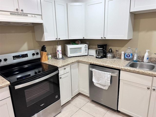 531 N Ocean Blvd Unit 1108, Pompano Beach, FL 33062 - kitchen with appliances with stainless steel finishes, under cabinet range hood, light countertops, and white cabinets