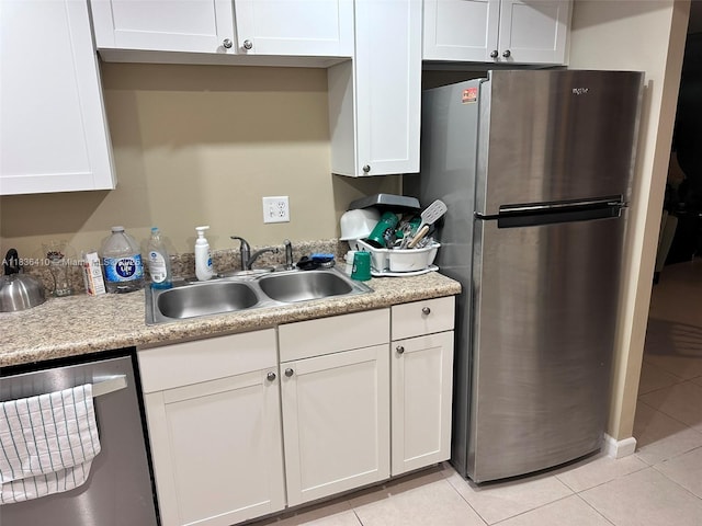 531 N Ocean Blvd Unit 1108, Pompano Beach, FL 33062 - kitchen with stainless steel appliances, light tile patterned floors, white cabinetry, and light countertops