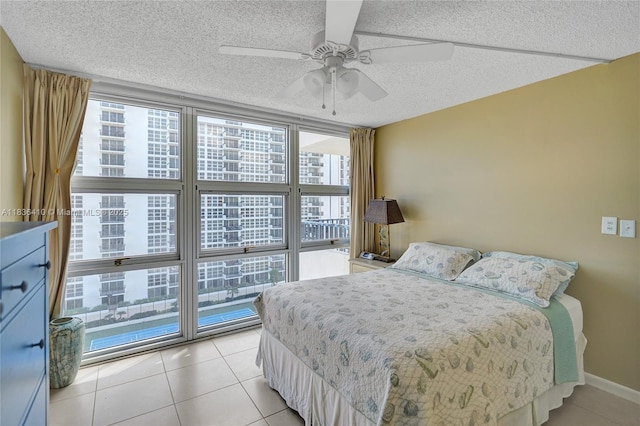 531 N Ocean Blvd Unit 1108, Pompano Beach, FL 33062 - bedroom with multiple windows, a textured ceiling, light tile patterned floors, a wall of windows, and ceiling fan