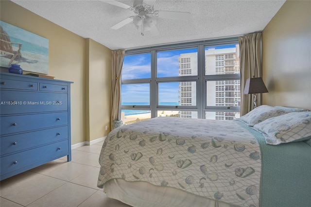 531 N Ocean Blvd Unit 1108, Pompano Beach, FL 33062 - bedroom with a textured ceiling, light tile patterned flooring, multiple windows, and a ceiling fan