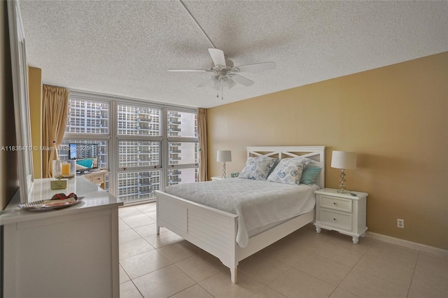 531 N Ocean Blvd Unit 1108, Pompano Beach, FL 33062 - bedroom featuring light tile patterned flooring, expansive windows, a textured ceiling, and ceiling fan