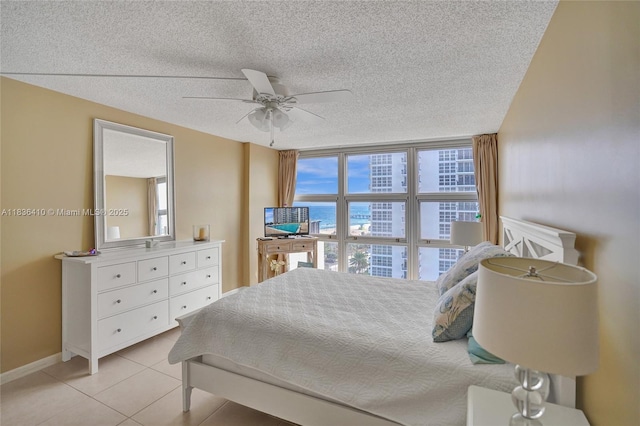 531 N Ocean Blvd Unit 1108, Pompano Beach, FL 33062 - bedroom featuring multiple windows, a textured ceiling, light tile patterned floors, and a ceiling fan