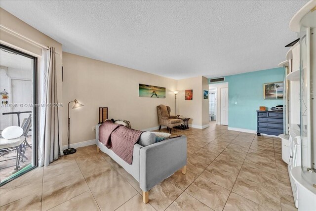 6555 W Broward Blvd Unit 300, Plantation, FL 33317 - bedroom with a textured ceiling and access to outside