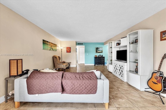 6555 W Broward Blvd Unit 300, Plantation, FL 33317 - living area featuring light tile patterned floors and a textured ceiling