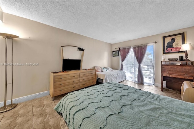 6555 W Broward Blvd Unit 300, Plantation, FL 33317 - bedroom featuring light tile patterned flooring, access to outside, and a textured ceiling