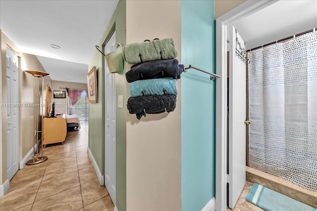 6555 W Broward Blvd Unit 300, Plantation, FL 33317 - corridor with baseboards and light tile patterned floors
