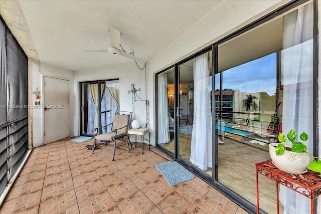 6555 W Broward Blvd Unit 300, Plantation, FL 33317 - sunroom with ceiling fan and brick patterned flooring