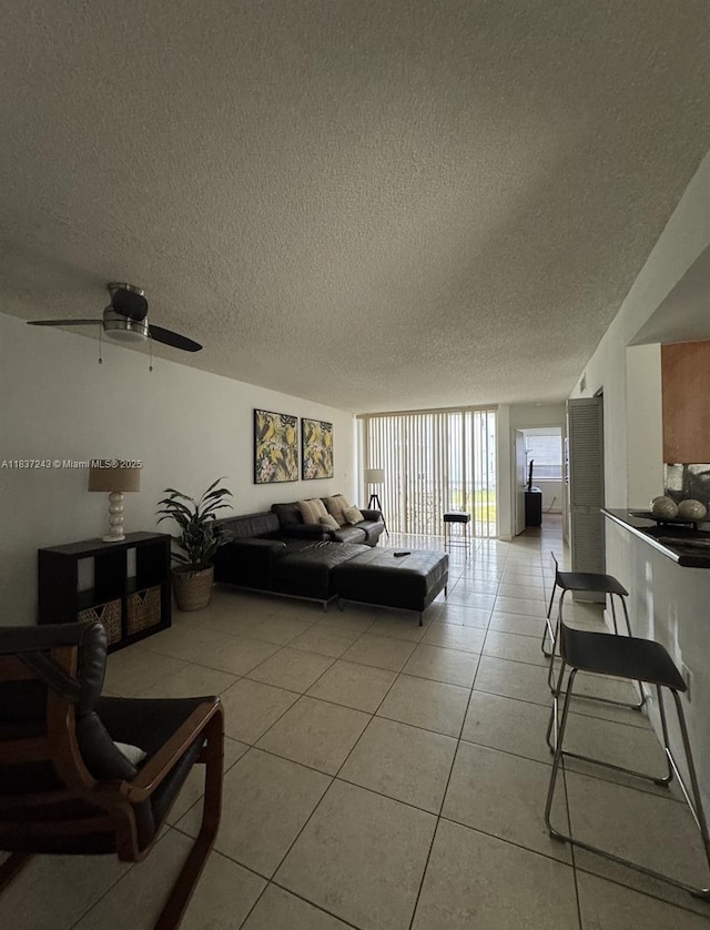 9755 NW 48th Ter Unit 321, Doral, FL 33178 - living area with a textured ceiling, light tile patterned floors, and ceiling fan