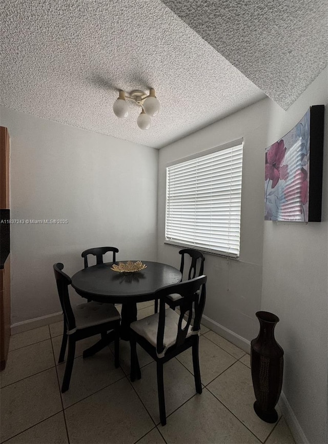 9755 NW 48th Ter Unit 321, Doral, FL 33178 - tiled dining area featuring a textured ceiling and baseboards