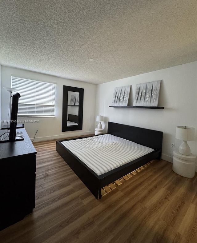 9755 NW 48th Ter Unit 321, Doral, FL 33178 - bedroom with wood finished floors and a textured ceiling