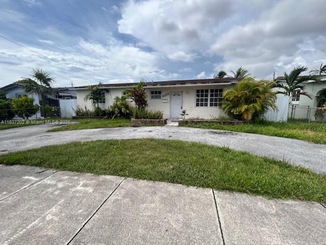 10060 SW 4th St, Sweetwater, FL 33174 - single story home with curved driveway and stucco siding