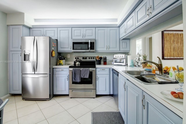 2524 NW 104th Ave Unit 101, Sunrise, FL 33322 - kitchen with stainless steel appliances, light countertops, light tile patterned floors, and gray cabinets